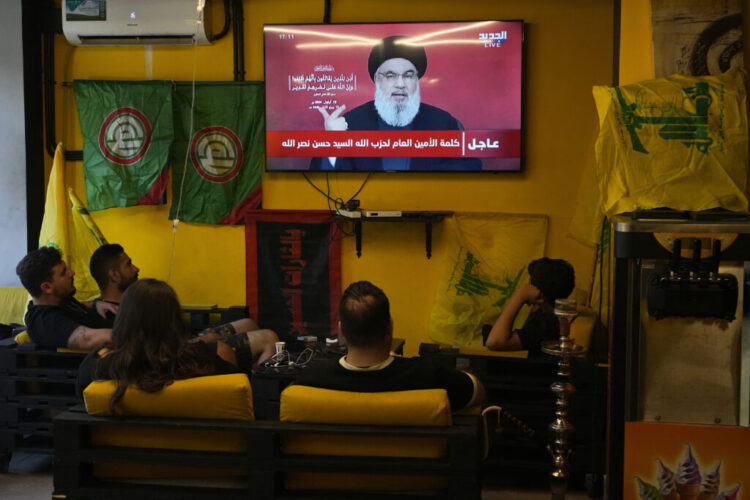 People watch the speech of Hezbollah leader Hassan Nasrallah as they sit in a cafe in the southern suburbs of Beirut, Thursday, Sept. 19, 2024. (AP Photo/Hassan Ammar)