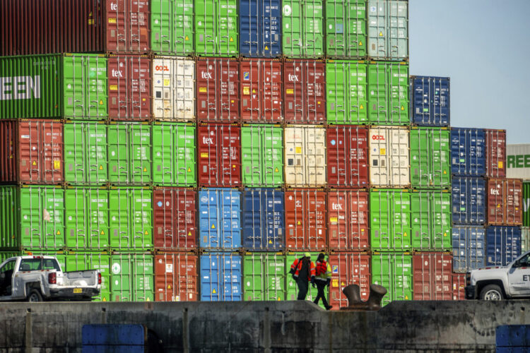 Dockworkers secure lines from a container ship at the Port of Oakland on Friday, April 4, 2025, in Oakland, Calif. (AP Photo/Noah Berger)